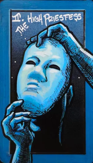 A tarot painting of The High Priestess. A smooth, pale blue mask floats in the center, its empty eyes gazing upward. Two blue-toned hands frame the mask, one holding from below, the other pressing at the temple, suggesting concealment or unveiling. The background is deep black speckled with stars, framed by a bold blue border. At the top, white text reads “II. The High Priestess.” The image conveys secrecy, hidden knowledge, and the tension between what is revealed and concealed.
